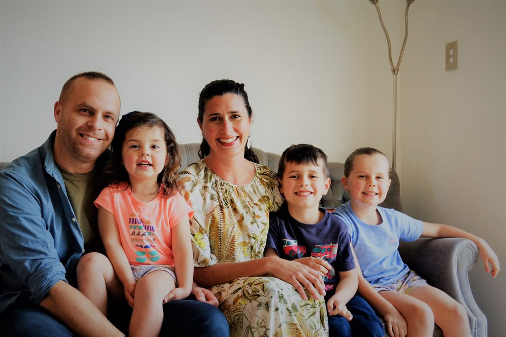 Family of 5 sitting on a sofa